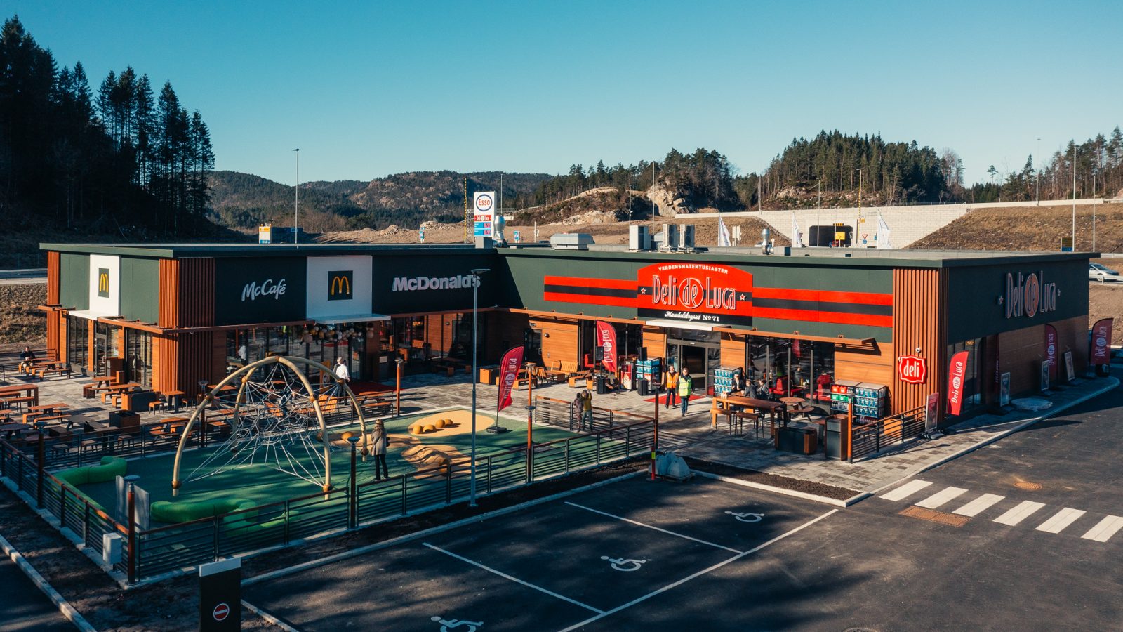Aerial view of a modern convenience retail forecourt at golden hour